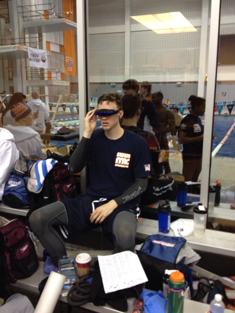 Athlete testing blackout goggles on pool deck